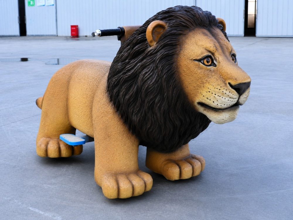 A black-maned lion electric ride-on with handlebars and footrests